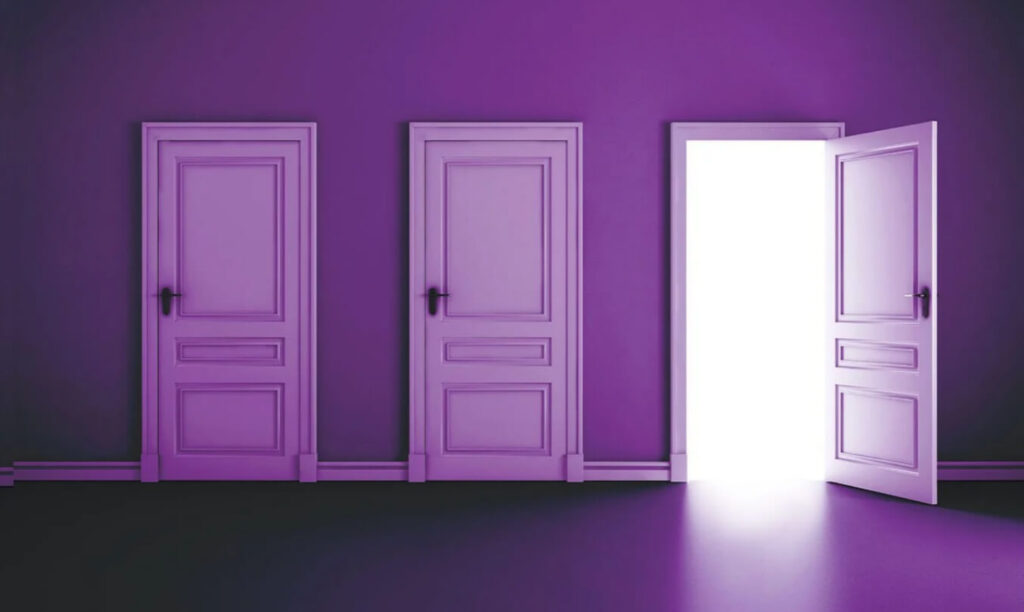 A room with three closed doors and one door partially open, revealing a bright white light emanating from the opening. The walls and doors are painted in a vibrant purple color, creating a surreal and visually striking atmosphere. The floor reflects the purple tones, enhancing the overall monochromatic theme of the space.