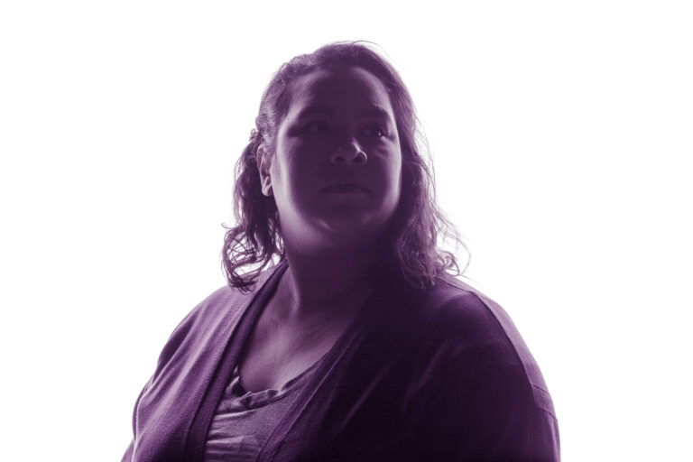 Survivor Facing Away with purple lighting casted on her